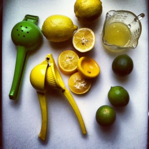 citrus press with limes and lemons